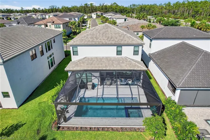 Aerial perspective of suburban area with a pool area