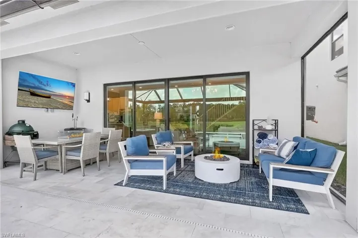 View of patio with an outdoor living space with a fire pit and outdoor dining space