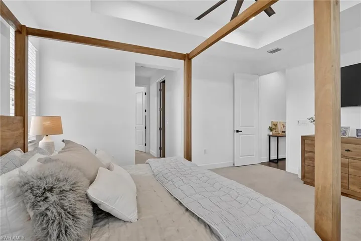 Carpeted bedroom featuring baseboards and ceiling fan