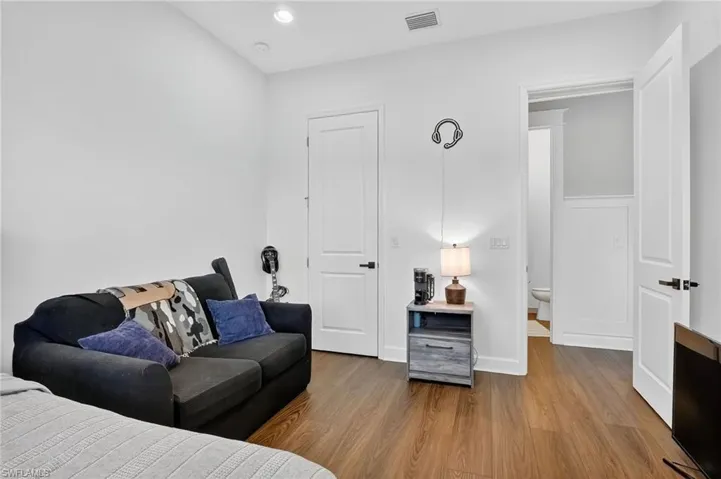 Bedroom with wood finished floors and recessed lighting