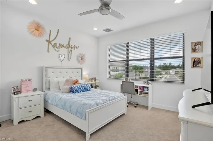 Carpeted bedroom with ceiling fan and recessed lighting