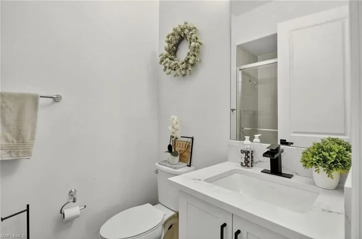 Bathroom with vanity and a shower with shower door