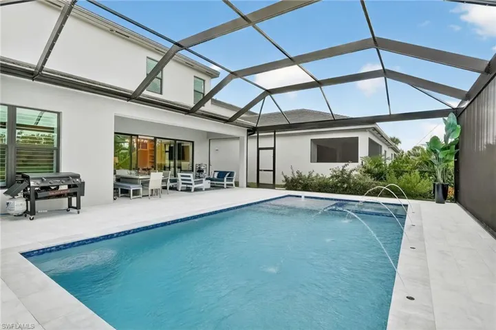 Outdoor pool featuring a patio, a lanai, and a sunroom