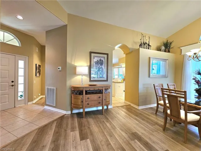 Foyer featuring lofted ceiling, a chandelier, and light hardwood / wood-style flooring