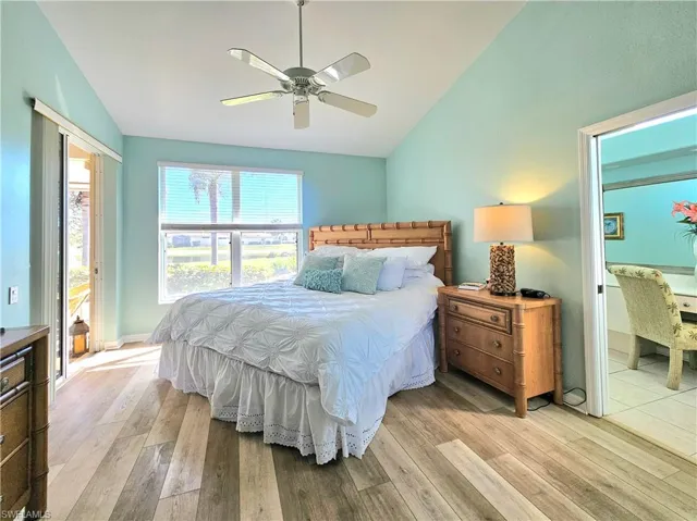 Bedroom with vaulted ceiling, light hardwood / wood-style floors, and ceiling fan