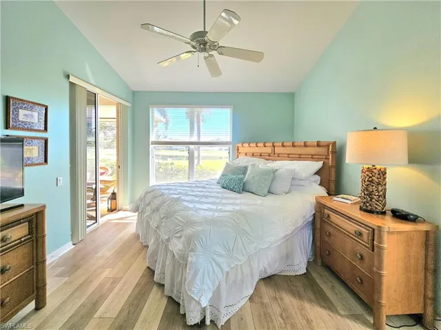 Bedroom with vaulted ceiling, ceiling fan, light wood-type flooring, and a closet