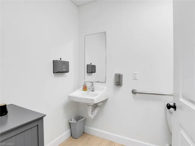 Bathroom with baseboards and light floors