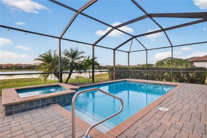 View of swimming pool featuring a water view, a lanai, a sunroom, and a patio