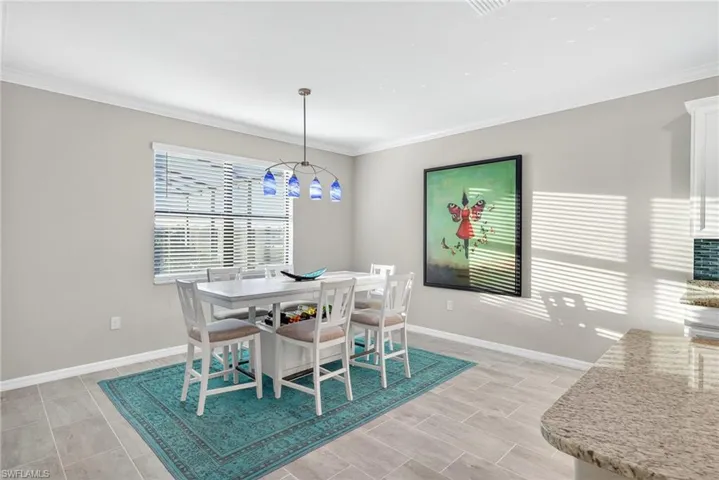 Dining room with baseboards and crown molding