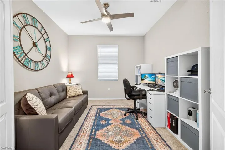 Office space featuring light carpet and ceiling fan