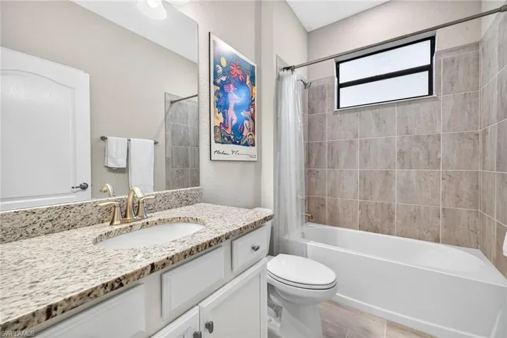Full bath featuring shower / tub combo with curtain and vanity