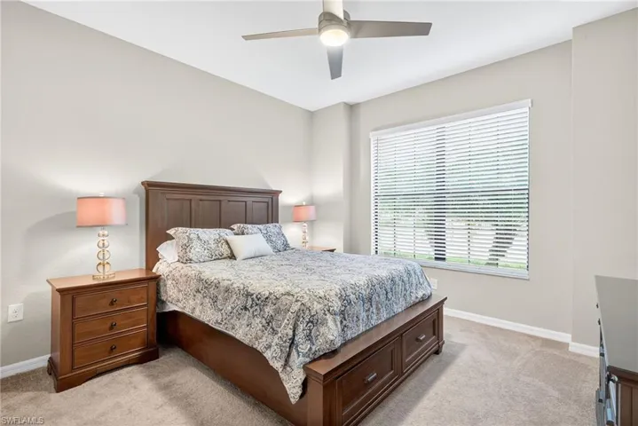Bedroom featuring a ceiling fan and light colored carpet