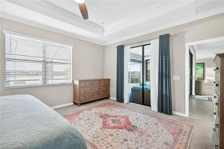 Bedroom with access to outside, light carpet, multiple windows, a ceiling fan, and crown molding