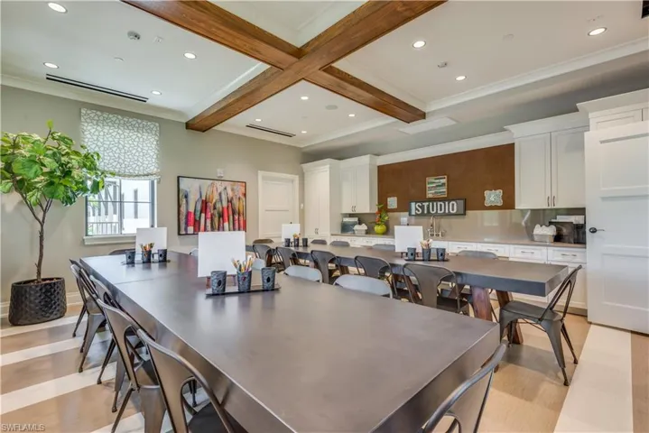 Dining space with beamed ceiling, ornamental molding, and recessed lighting