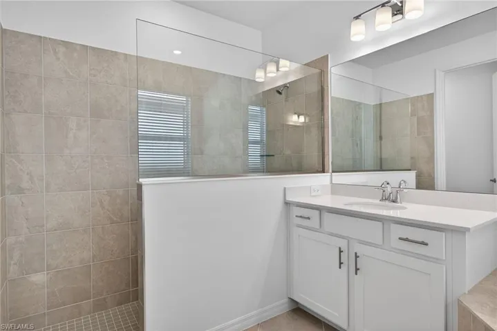 Primary Bathroom featuring vanity and walk in shower