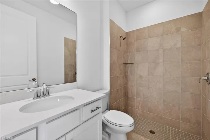 Bathroom with vanity and a shower stall