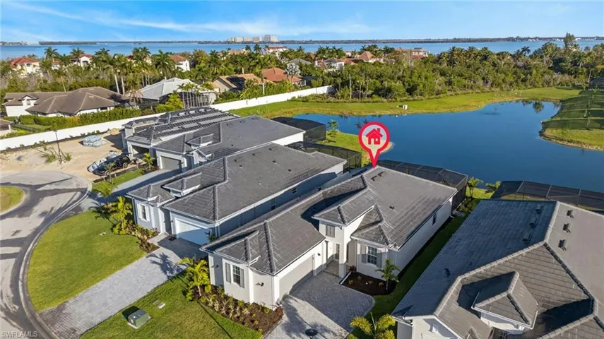 Aerial view of residential area featuring a nearby body of water