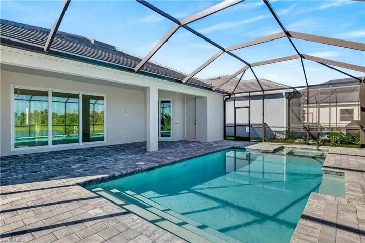 Integrated pool / spa featuring a sunroom, a patio, and a lanai