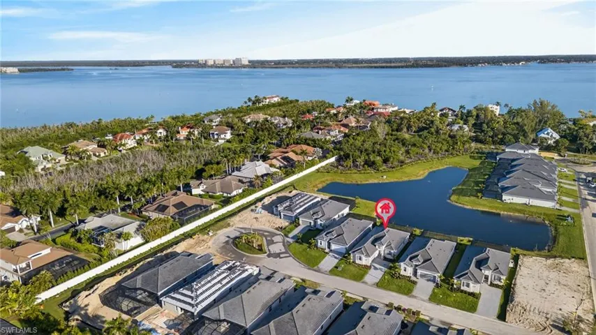 Aerial perspective of suburban area featuring a nearby body of water