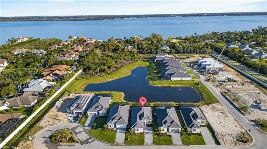 Aerial perspective of suburban area featuring a nearby body of water