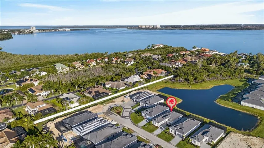 Aerial view of residential area featuring a nearby body of water