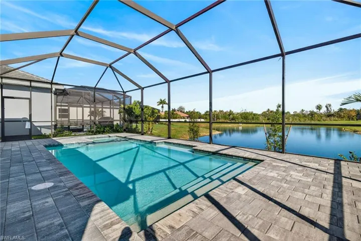 Swimming pool featuring a sunroom, glass enclosure, a water view, and a jacuzzi