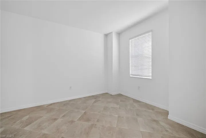 Den featuring baseboards