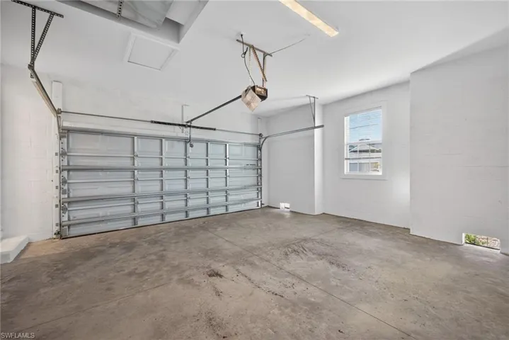 Garage featuring concrete block wall