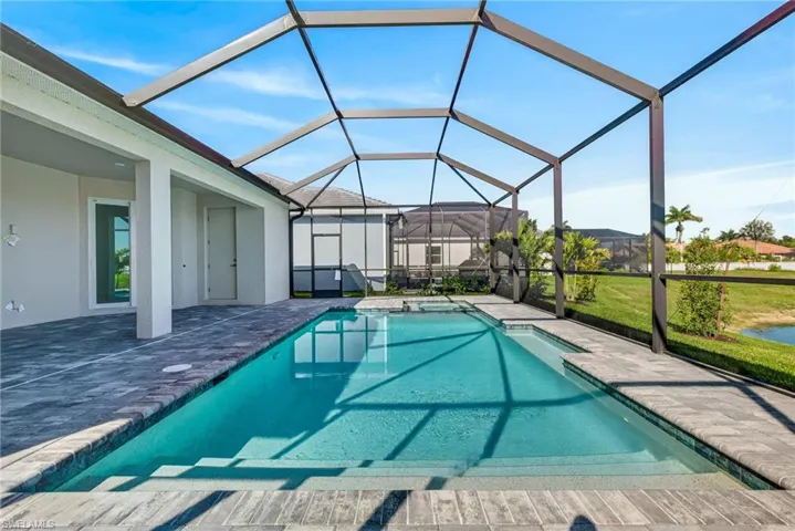 Outdoor pool featuring a sunroom, a lanai, a patio area, and a yard