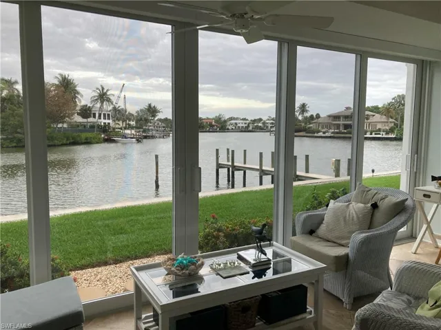 Sunroom / solarium featuring a water view