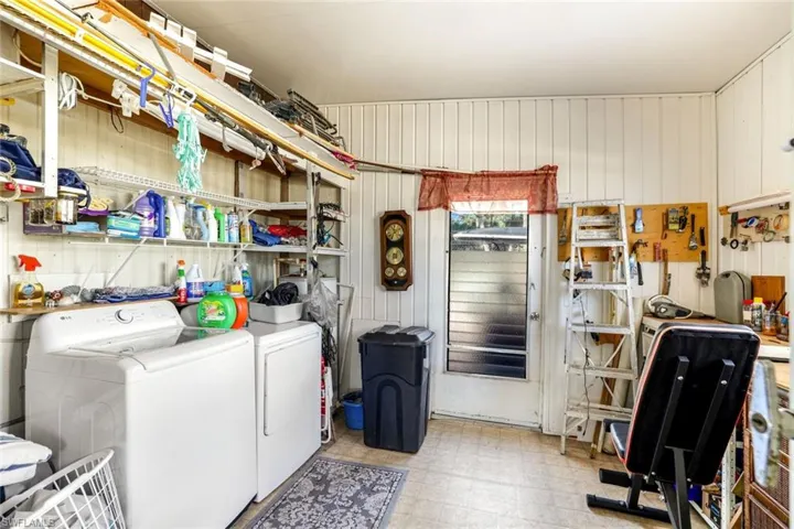Laundry area with light floors and separate washer and dryer