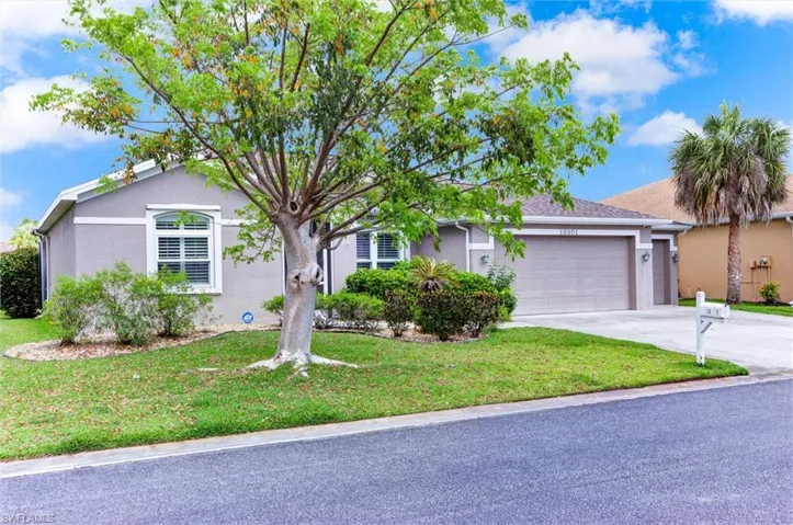 Single-story home featuring a gray stucco exterior, white window trim, and an attached two-car garage