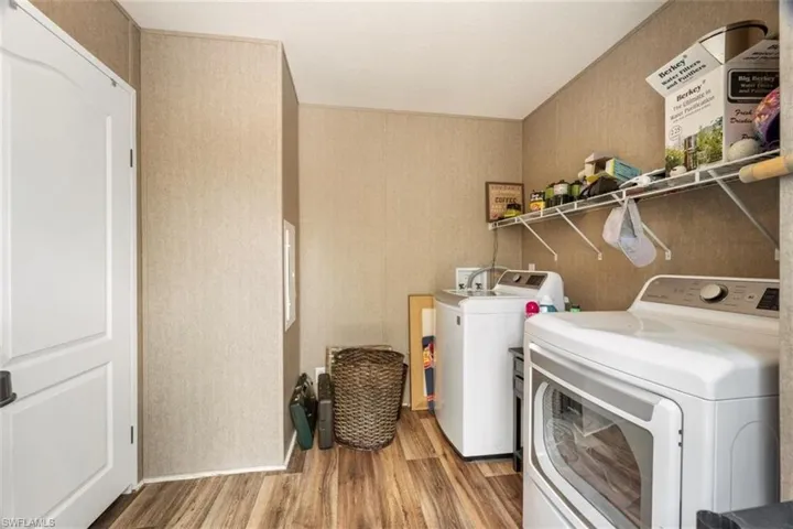 Clothes washing area with independent washer and dryer and wood-type flooring