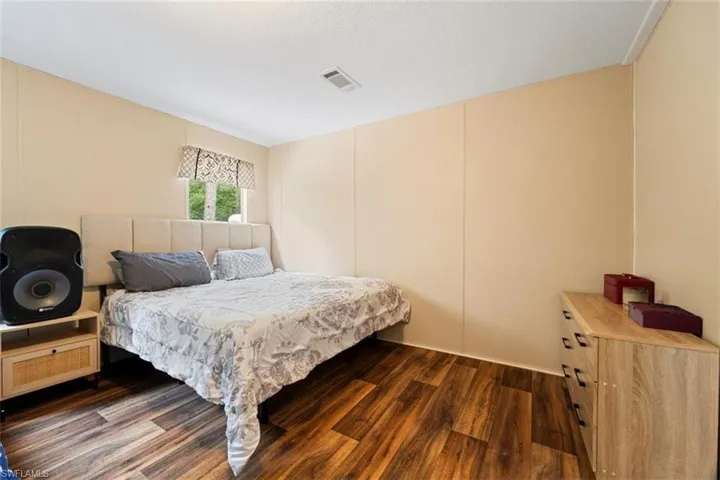 Bedroom with dark hardwood / wood-style floors