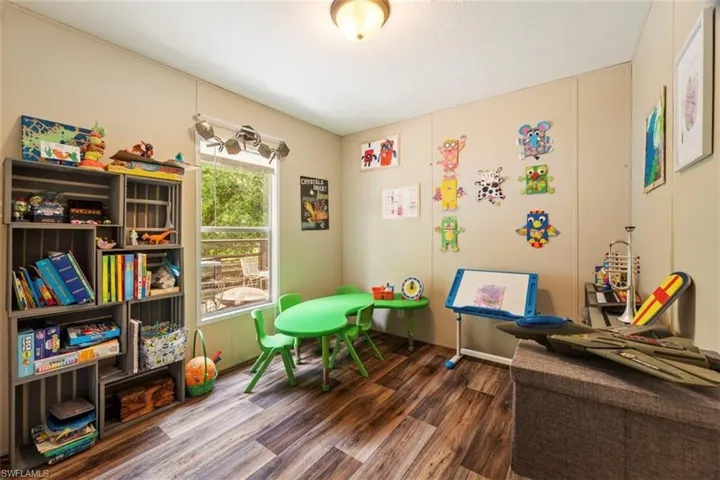 Recreation room featuring dark hardwood / wood-style floors