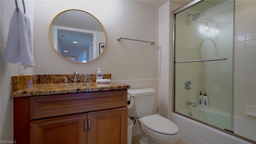Guest Bath has granite counters, wood cabinets, has tub shower combo, conveniently located between bedrooms 2 and 3. New paint and decor 2023