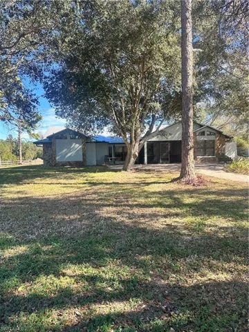 View of green lawn with a patio area