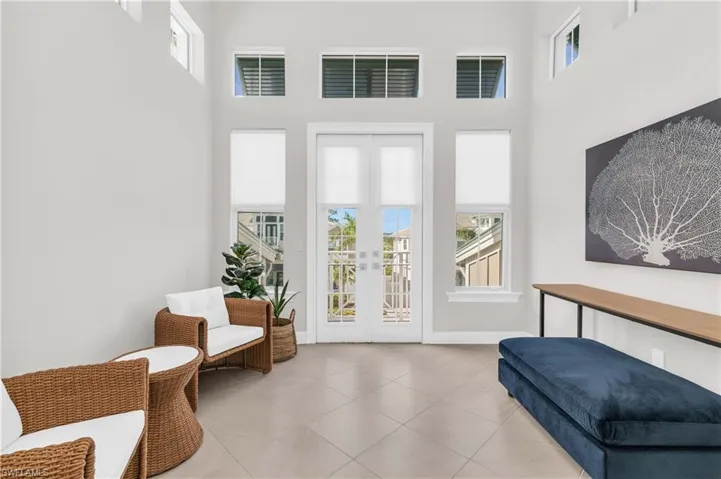 Living area with french doors and a towering ceiling