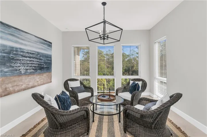 Sitting room featuring tile patterned flooring and a notable chandelier