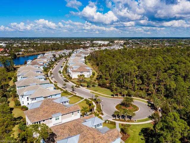 Birds eye view of property with a water view