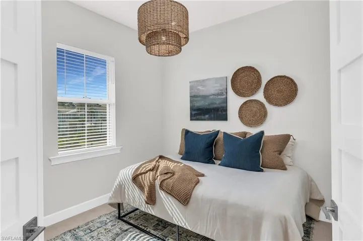 Bedroom featuring light carpet