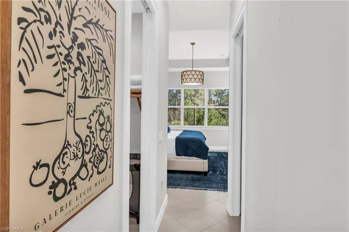 Corridor featuring light tile patterned floors