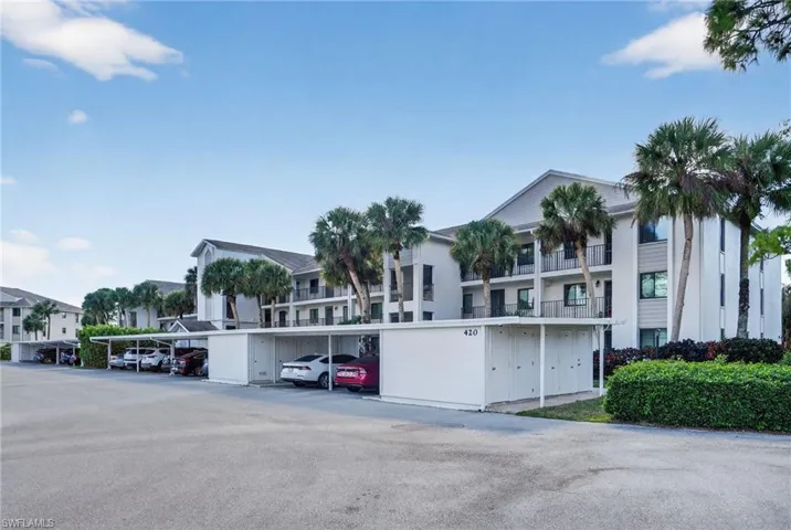 View of property featuring covered parking