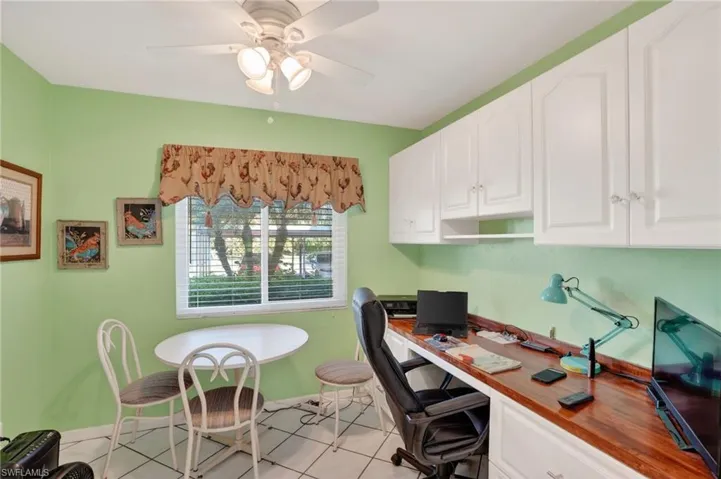 Office with ceiling fan and light tile patterned floors