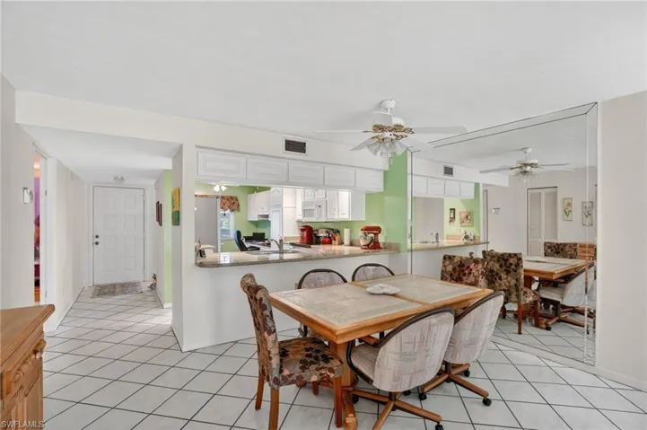 Dining room with light tile patterned floors and ceiling fan