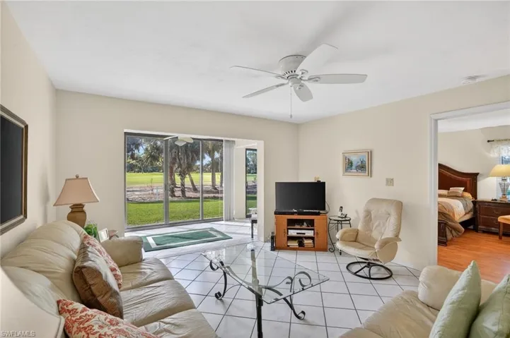 Living room featuring healthy amount of natural light and a ceiling fan