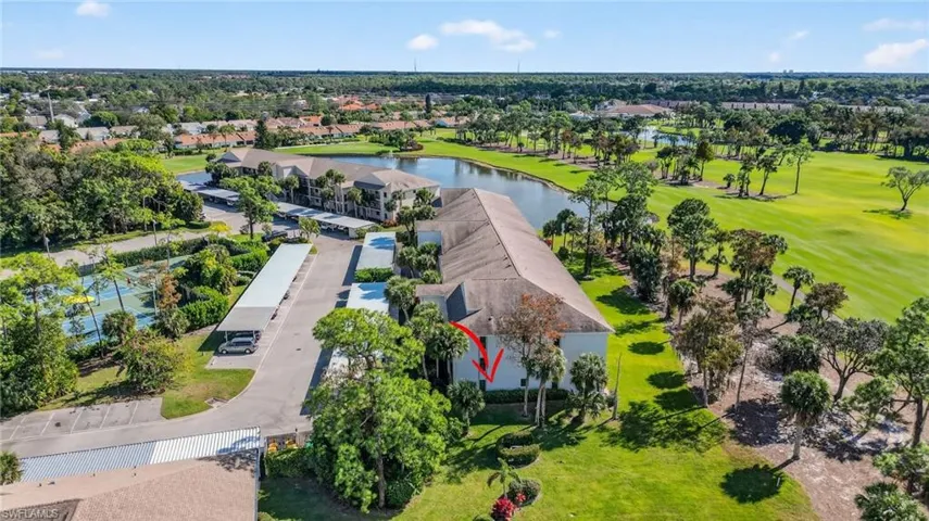 Drone / aerial view of a local golf course and a nearby body of water