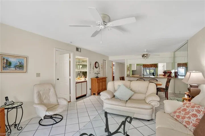 Tiled living room featuring ceiling fan