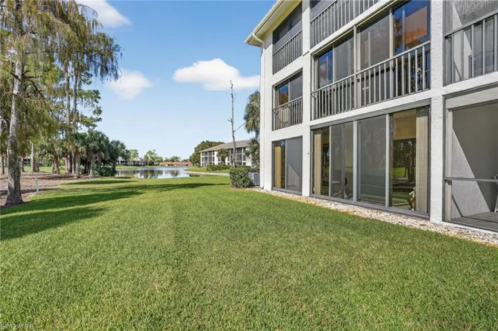 View of green lawn featuring a water view