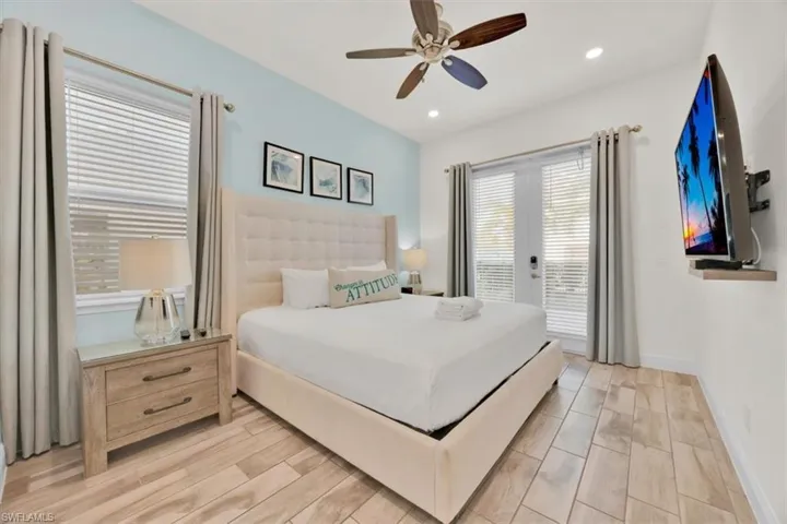 Bedroom with access to outside, ceiling fan, wood finish floors, and recessed lighting